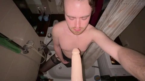 La shemale Austin Nicks, vêtue de lingerie, prend un faux pénis profondément, jouissant et urinant sur ses bas